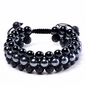 Macro detail of triple-layer beaded bracelet with lava rock, hematite and onyx beads