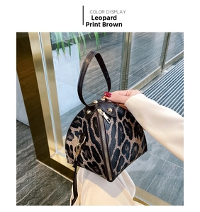 Detail of leopard print mini bag showing brown PU leather and gold metal zipper