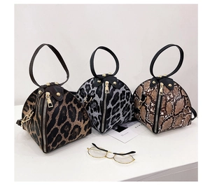 Detailed trio of leopard and snake print triangle bags with round handles and metal studs