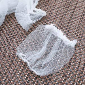White mesh sink strainer bags for kitchen drainage filtering on a brown woven background