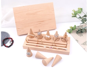 Macro detail of natural beech wood cone ring stands and slotted jewelry display base