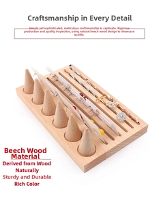Detail view of beech wood jewelry tray with six ring cones and card slots for earrings