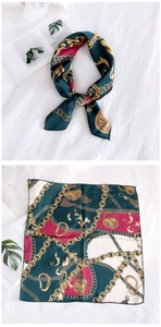 Detailed pattern view of elegant square silk scarf with golden chain print in dark green