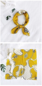 Detailed pattern display of yellow silk square scarf with golden chain and jewel prints