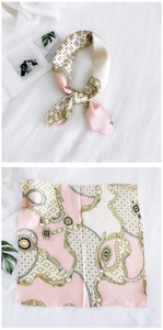 Detail of silk square scarf with vintage gold chain prints and pink patchwork patterns