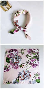 Detail of floral print on light pink silk scarf with refined edge stitching