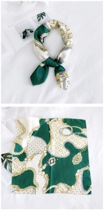 Detailed pattern of chain and medal prints on vintage dark green and beige silk scarf