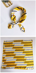 Detail of a yellow silk scarf with black and white stripes and geometric patterns