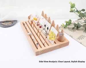 Detail view of wooden jewelry display rack with ring cones and slotted slots for earrings