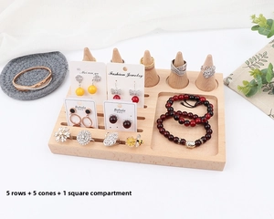 Detail of wooden jewelry organizer with five conical ring stands and earring card slots