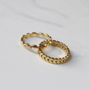 18K gold plated wheat ear and heart ring set on grey marble background