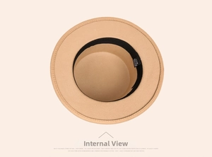 Macro shot of camel wool fedora hat interior showing black sweatband and size M label
