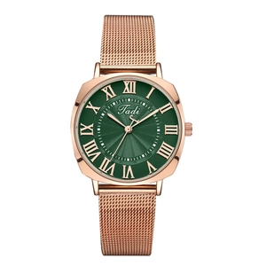 Close-up of Tadi rose gold mesh watch featuring a deep green sunray dial and Roman numerals