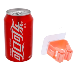 Wall-mounted mop holder with pink roller clip and adhesive back next to a soda can