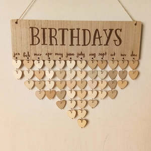 Close-up of wooden birthday calendar board with heart shapes and monthly engravings
