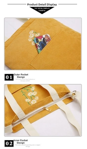 Detail of yellow corduroy tote bag with daisy embroidery and white strap handles