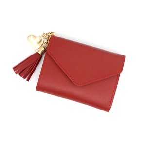 Short red tri-fold women's wallet with envelope flap, gold heart charm and tassel detail