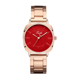 Detail of rose gold quartz watch featuring a vibrant red dial with polished metal markers