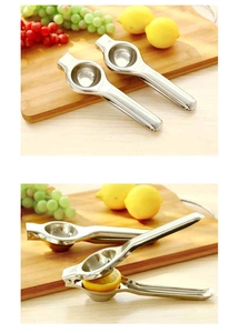 Close-up of stainless steel manual lemon squeezer set on a rustic wooden background