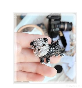 Detailed view of bulldog brooch with black and white rhinestones held in hand