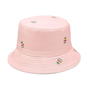 Close-up of pink bucket hat featuring detailed colorful pineapple embroidery and cotton stitching