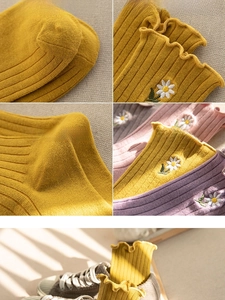 Detail of ruffled cuffs and daisy embroidery on ribbed cotton crew socks for women