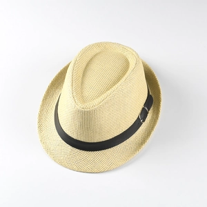 Detailed macro view of woven straw texture with black ribbon and silver metal buckle