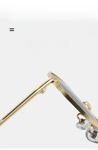 Detail of high-quality golden metal frame hinge with textured edges and soft nose pads