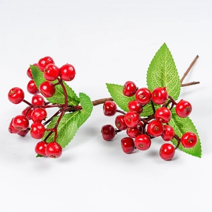 Artificial red berry branch with green leaves for Christmas home decoration on white background