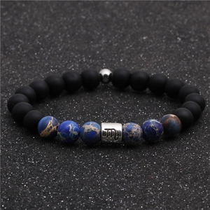 Detail of Scorpio zodiac bracelet with matte black beads and blue imperial stone