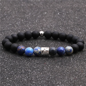 Detailed view of Sagittarius sign on black matte beads and blue imperial stone bracelet