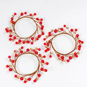 Three-piece Christmas candle ring set with red and gold berries on brown vine base