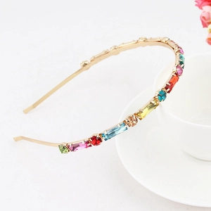 Detail of colorful rhinestones and crystals on a thin gold metal bohemian headband
