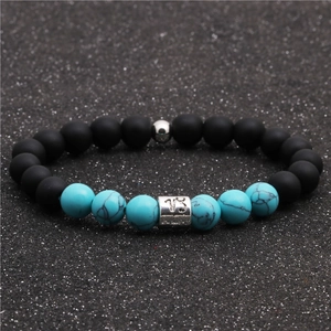Macro shot of Capricorn zodiac bead with black matte and turquoise stone beads