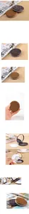 Close-up of a chocolate cookie-shaped foldable mirror with a built-in hair comb