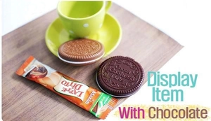 Close-up of chocolate biscuit mirror with cocoa pattern engraving and mini latte stick