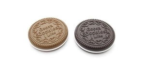 Detail of cocoa cookies shaped portable folding mirror and comb set in brown and black
