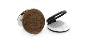Macro detail of portable chocolate cookie folding mirror and hair comb set in brown