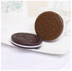 Close-up of chocolate cookie shaped compact mirror and comb set in a tea setting