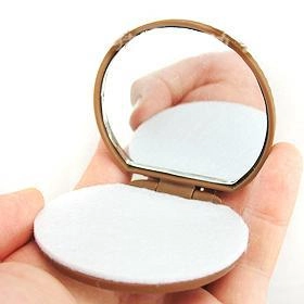 Mini brown chocolate cookie shaped folding mirror and hair comb set in hand