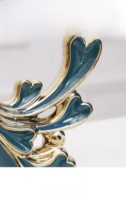 Macro detail of dark green ceramic ornament featuring elegant electroplated gold edges