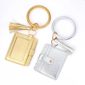 Close-up of PU leather coin purse with metallic ring, tassels and litchi texture