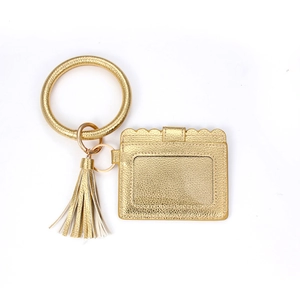 Detail of golden lychee pattern leather keyring with large circle bracelet and card slot