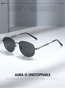Detailed view of oval metal frame sunglasses with polarized lenses and sharp shadows