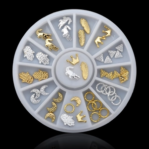 Detailed set of gold and silver metal nail art charms in a circular 12-slot storage case