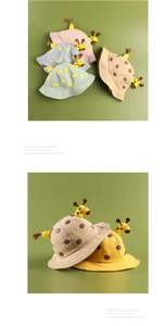 Detail showing various colors of children's cotton giraffe bucket hats with 3D ears