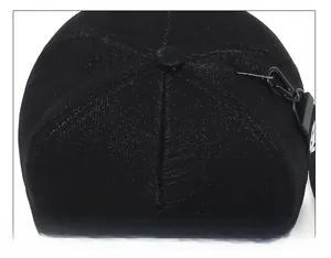 Detailed top view of a black baseball cap featuring six-panel stitching and a metal hook accessory