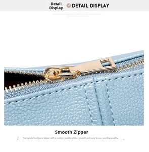Close-up of smooth gold zipper hardware on light blue litchi texture leather handbag