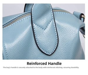 Detail of reinforced stitching and litchi texture on light blue leather handbag