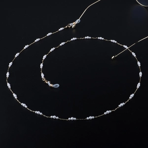 Minimalist pearl glasses chain with gold plating and white pearls on black background